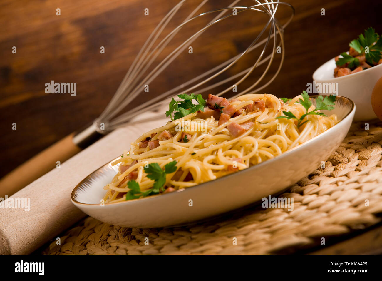 Delicious spaghetti with bacon and egg called alla carbonara on wooden