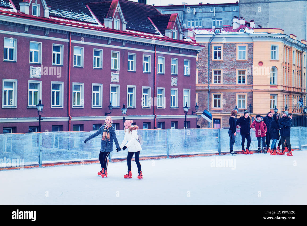 Tallinn, Estonia February 27, 2017 Teenagers ice skating on the rink at the Old town of