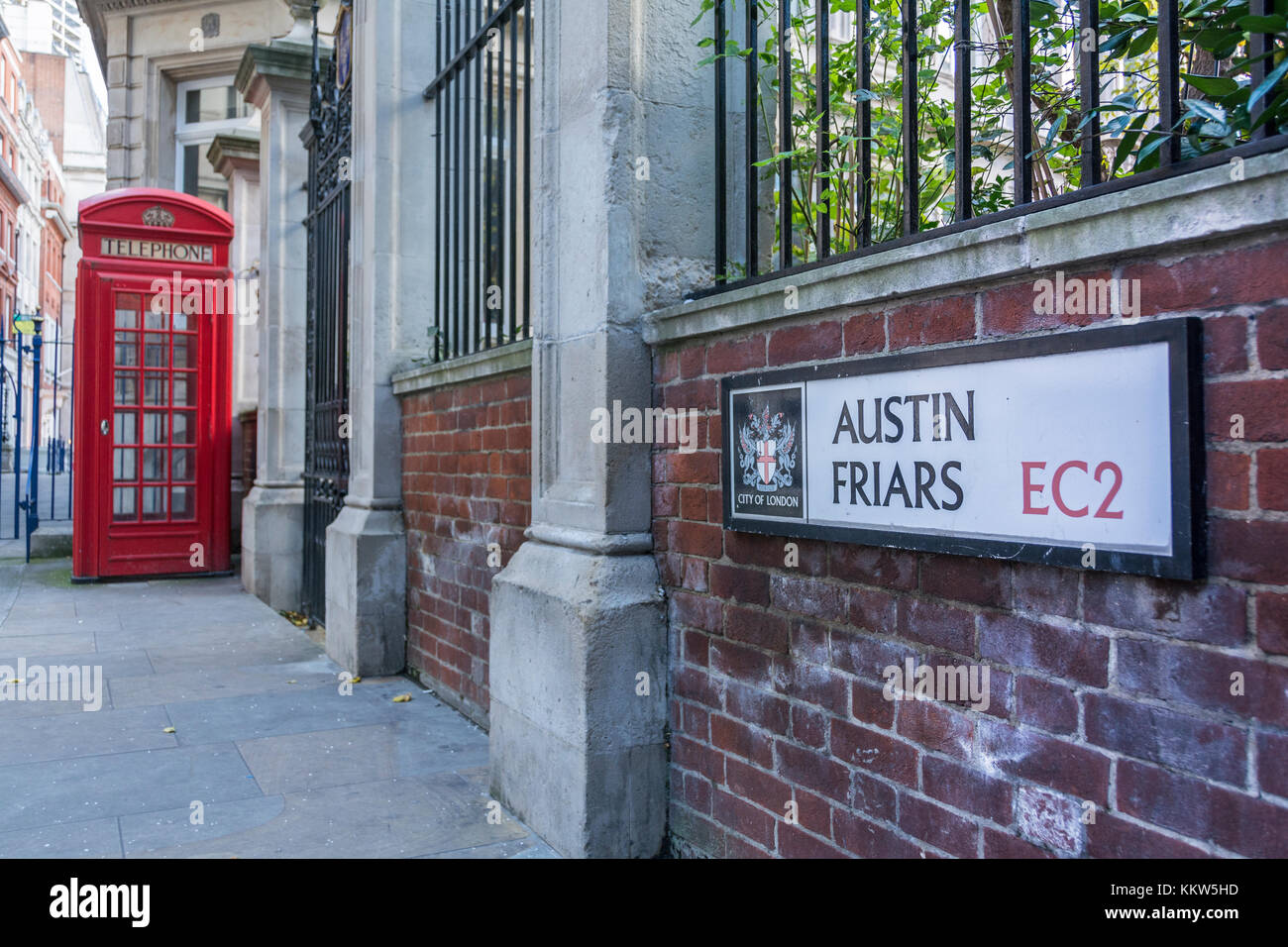 A red telephone box and street sign on Austin Friars in the City of London, EC2, UK Stock Photo