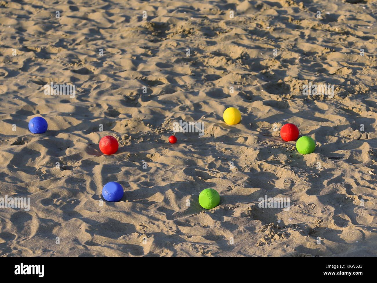 Six game bowls and a small red jack on the sea beach in the summer Stock Photo