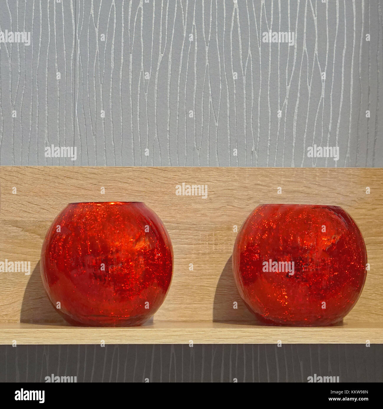 Two scented candles in red glass at shelf Stock Photo Alamy