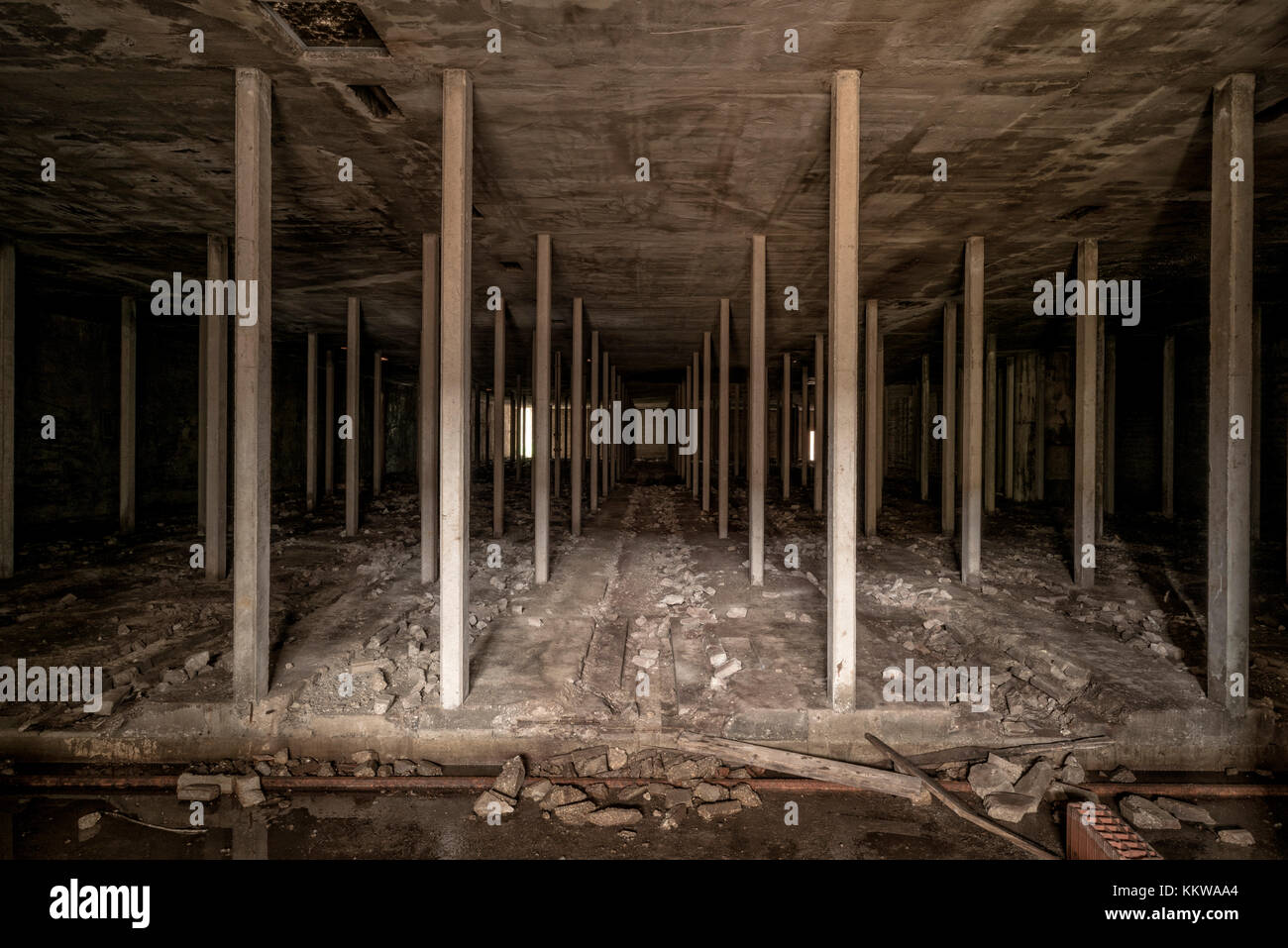 Dark colonnade space in abandoned factory Stock Photo