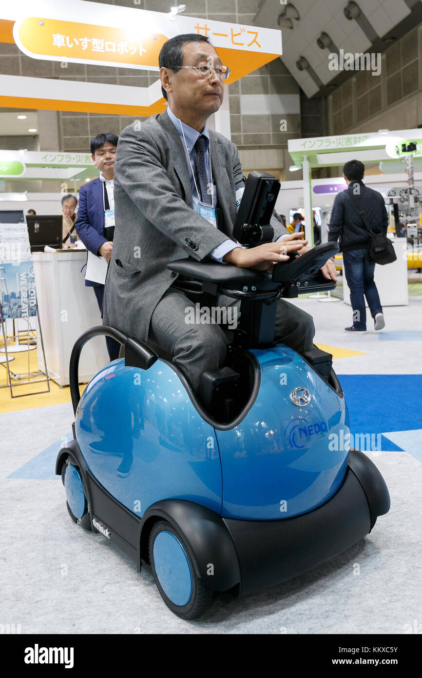 An exhibitor rides a mobile robot RODEM during International Robot  Exhibition 2017 in Tokyo Big Sight on December 2, 2017, Tokyo, Japan. The  annual exhibition introduces new robots and high technology equipments