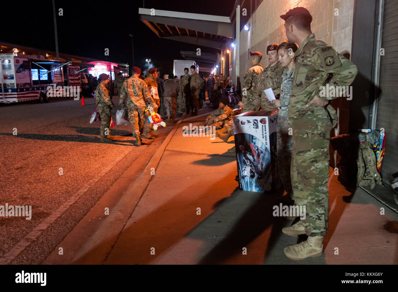 Fort Bragg, NC, USA. 1st Dec, 2017. Dec. 1, 2017 - FORT BRAGG, N.C., USA - Paratroopers line the street at Green Ramp on Pope Army Airfield, Friday, before the sun rises, waiting to donate their toys at the 20th Annual Randy Oler Memorial Operation Toy Drop. The airborne operation, hosted by the U.S. Army Civil Affairs & Psychological Operations Command (Airborne), is the world's largest combined airborne operation with paratroopers from nine allied nations participating. The annual event allows paratroopers the opportunity to help children in communities surrounding Fort Bragg Stock Photo