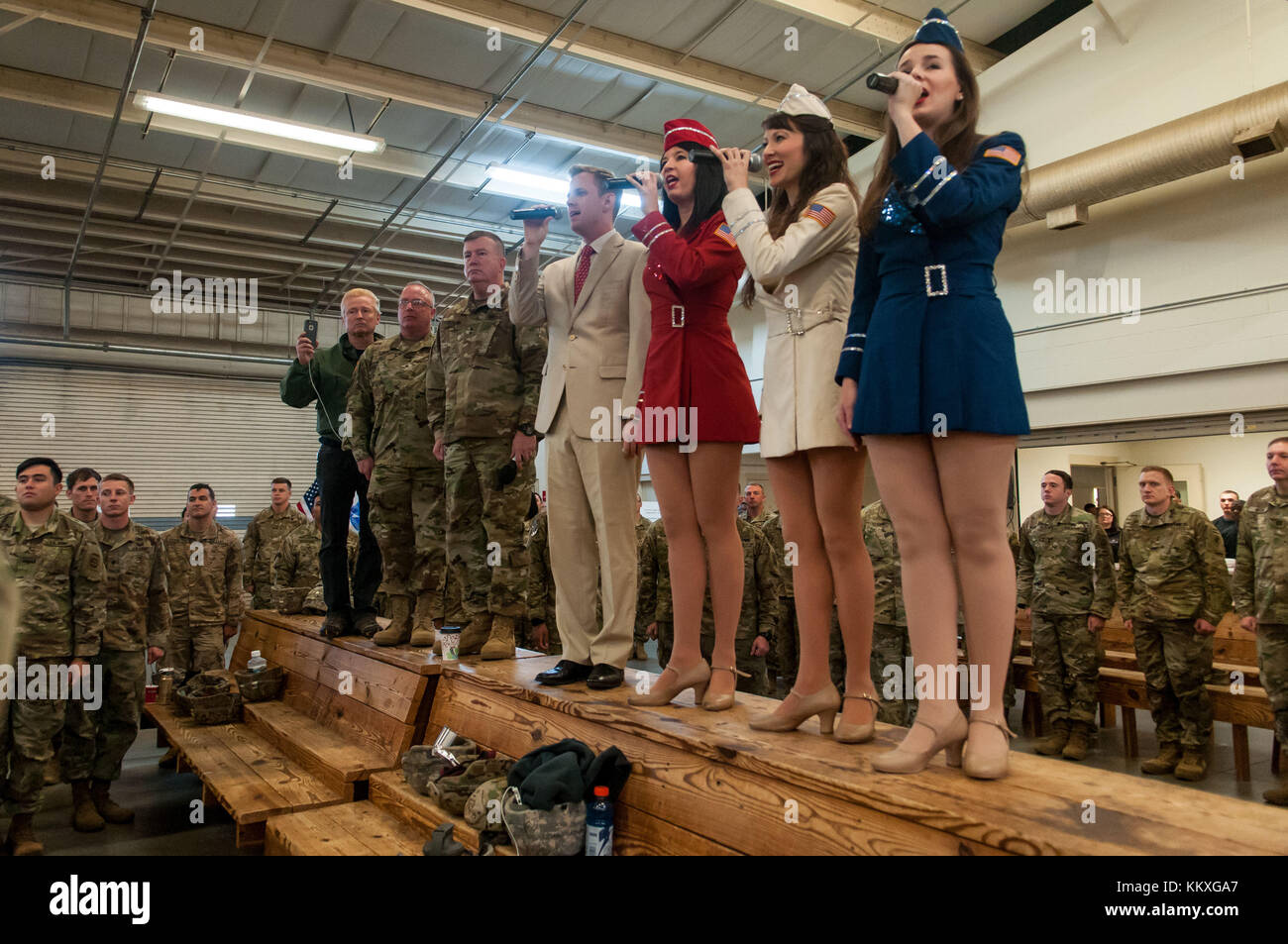 Fort Bragg, NC, USA. 1st Dec, 2017. Dec. 1, 2017 - FORT BRAGG, N.C., USA - The USO Singers perform the National Anthem at Green Ramp on Pope Army Airfield, Friday, at the 20th Annual Randy Oler Memorial Operation Toy Drop. The airborne operation, hosted by the U.S. Army Civil Affairs & Psychological Operations Command (Airborne), is the world's largest combined airborne operation with paratroopers from nine allied nations participating. The annual event allows paratroopers the opportunity to help children in communities surrounding Fort Bragg receive donated toys for the Christm Stock Photo