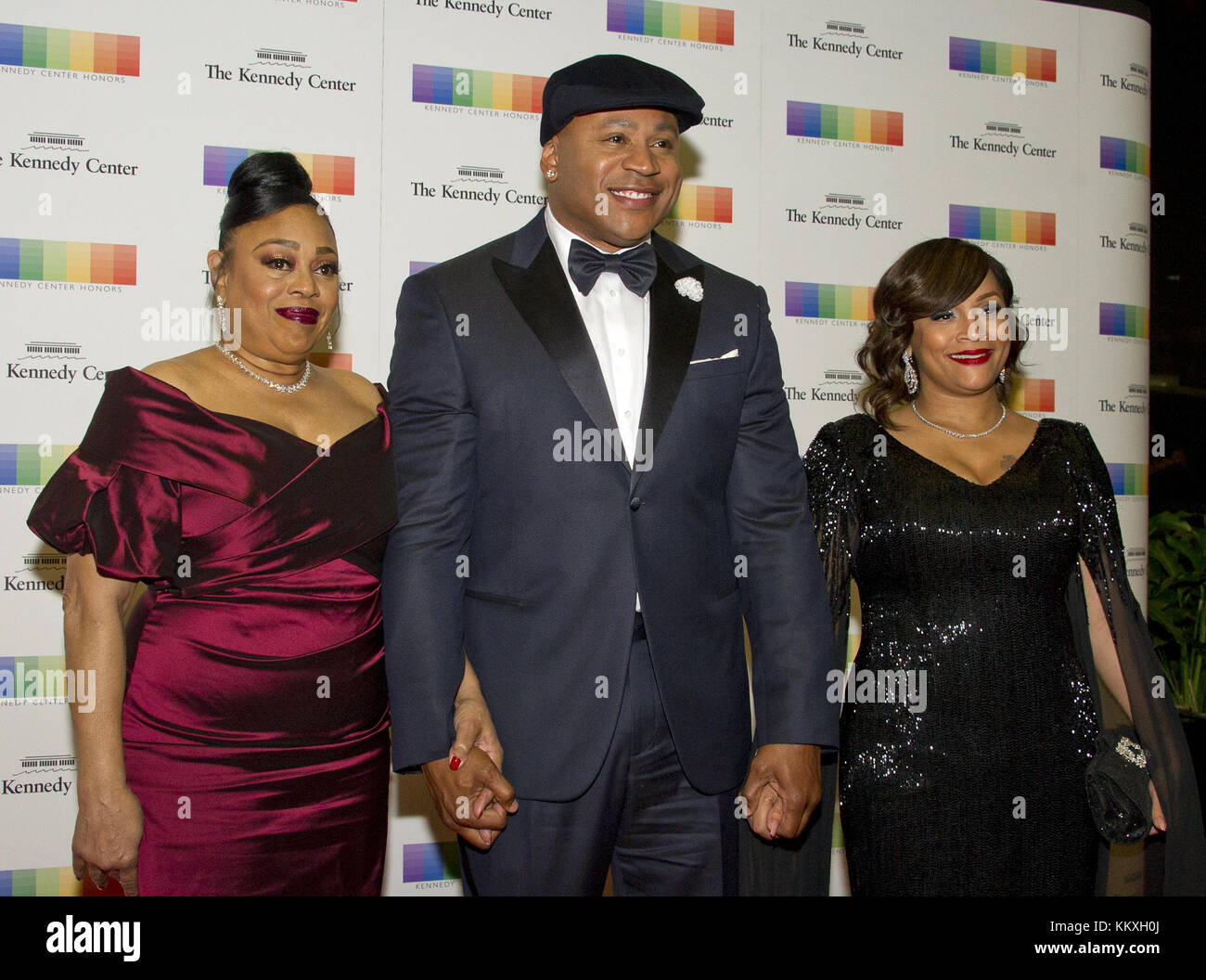 December 2, 2017 - Washington, District of Columbia, United States of America - LL COOL J, center, arrives with his Mother, Andrea Smith, left and his wife, Simone Smith, right, for the formal Artist's Dinner honoring the recipients of the 40th Annual Kennedy Center Honors hosted by United States Secretary of State Rex Tillerson at the US Department of State in Washington, DC on Saturday, December 2, 2017. The 2017 honorees are: American dancer and choreographer Carmen de Lavallade; Cuban American singer-songwriter and actress Gloria Estefan; American hip hop artist and entertainment icon LL Stock Photo