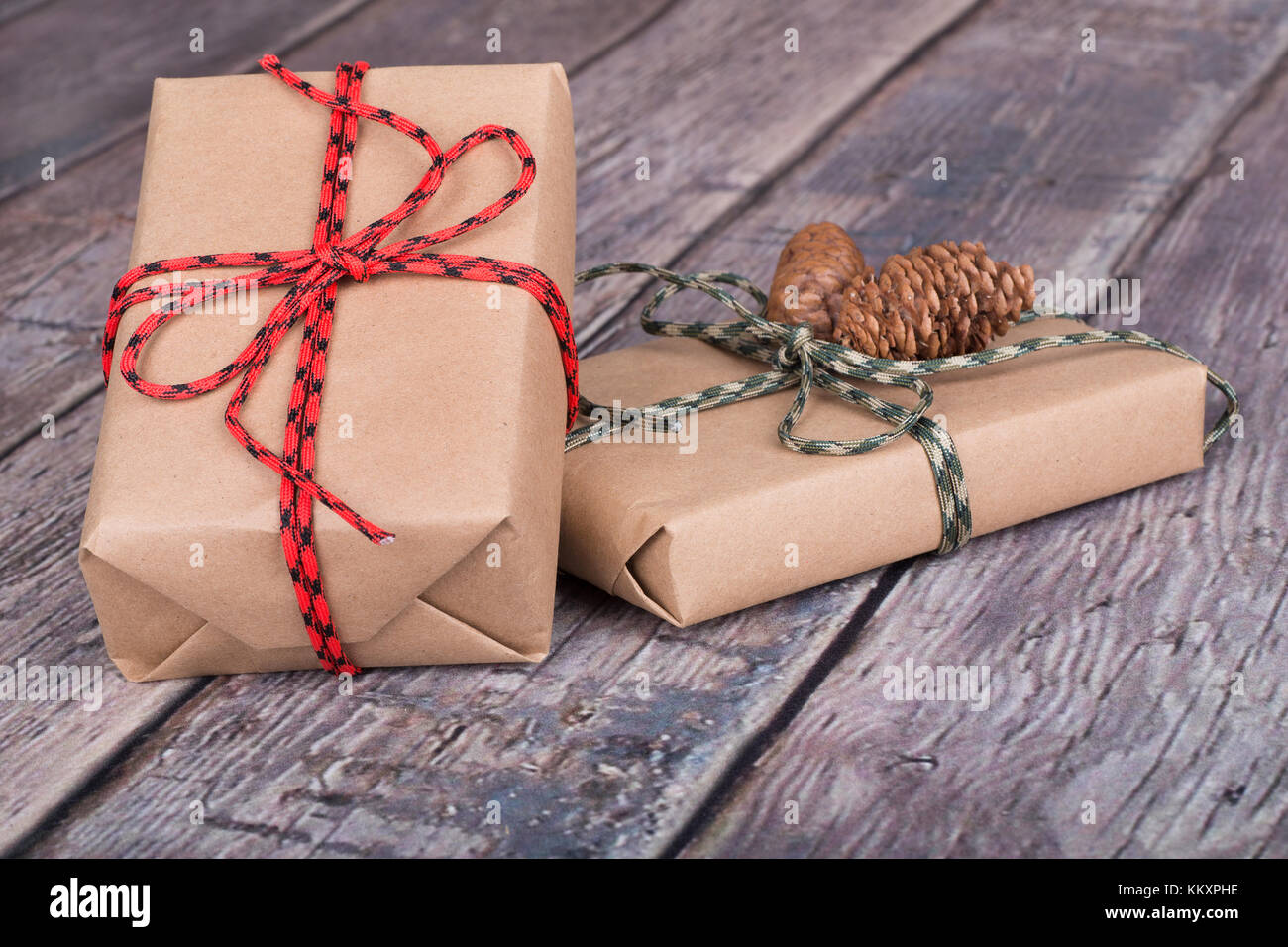 Two brown gift boxes tied with string on a wood textured surface Stock ...