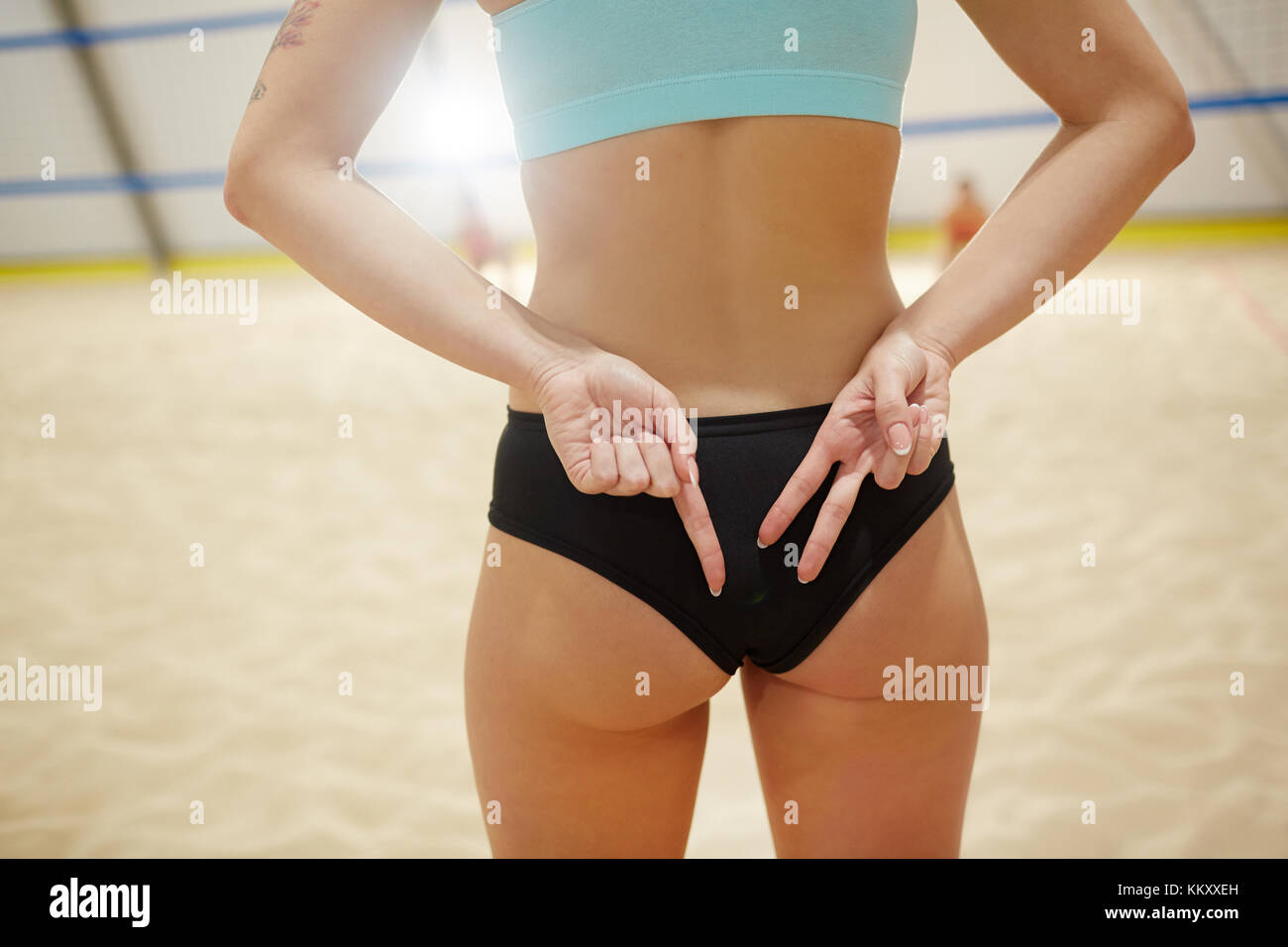 Fit sports judge keeping hands behind back while making score of the game Stock Photo