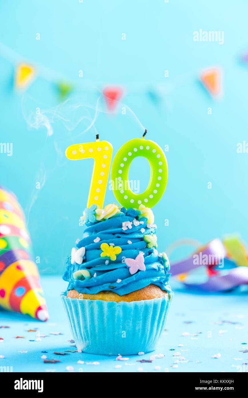 Seventieth 70th birthday cupcake with candle blow up and sprinkles. Card mockup. Stock Photo