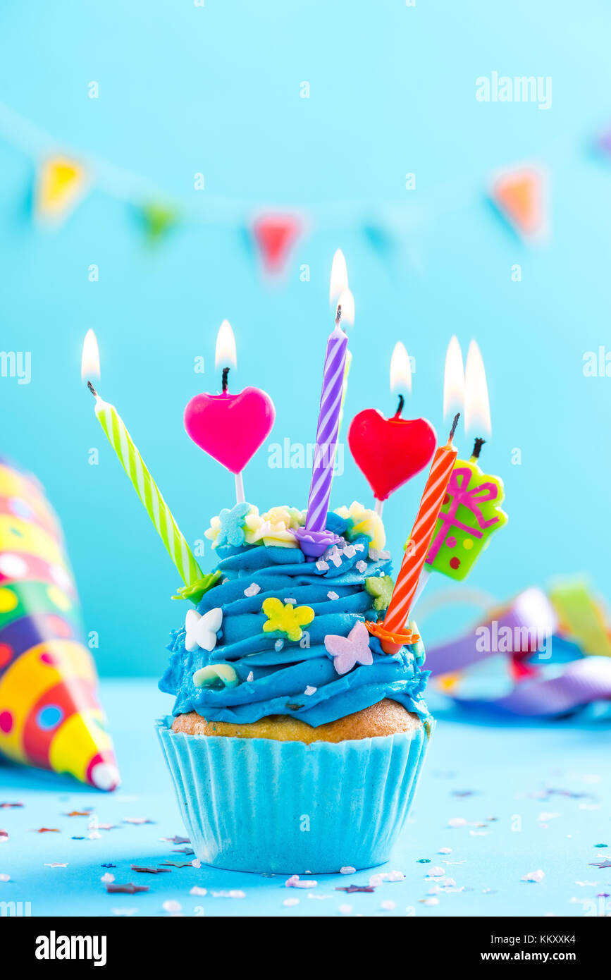 Colorful decorated cupcake with candles alight. Birthday card mockup ...