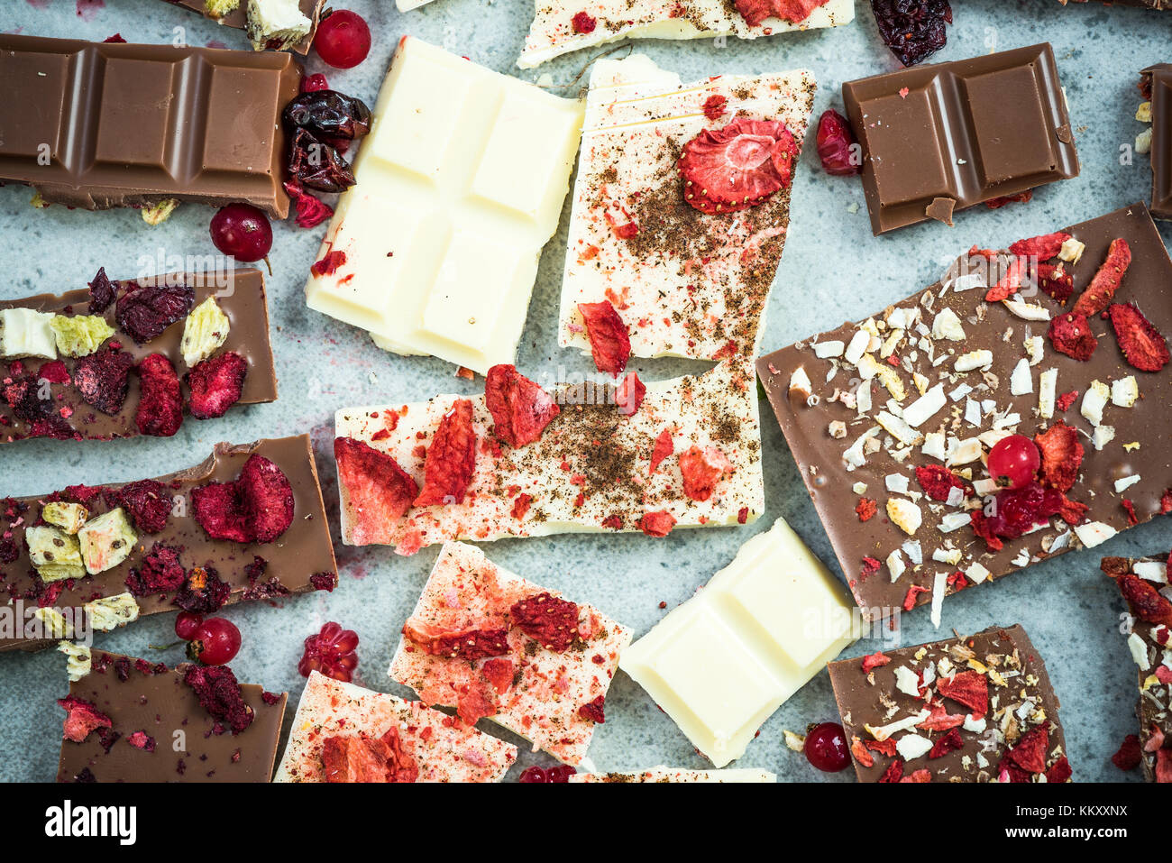 Pieces of handmade artisan chocolate bars with healthy dried fruits