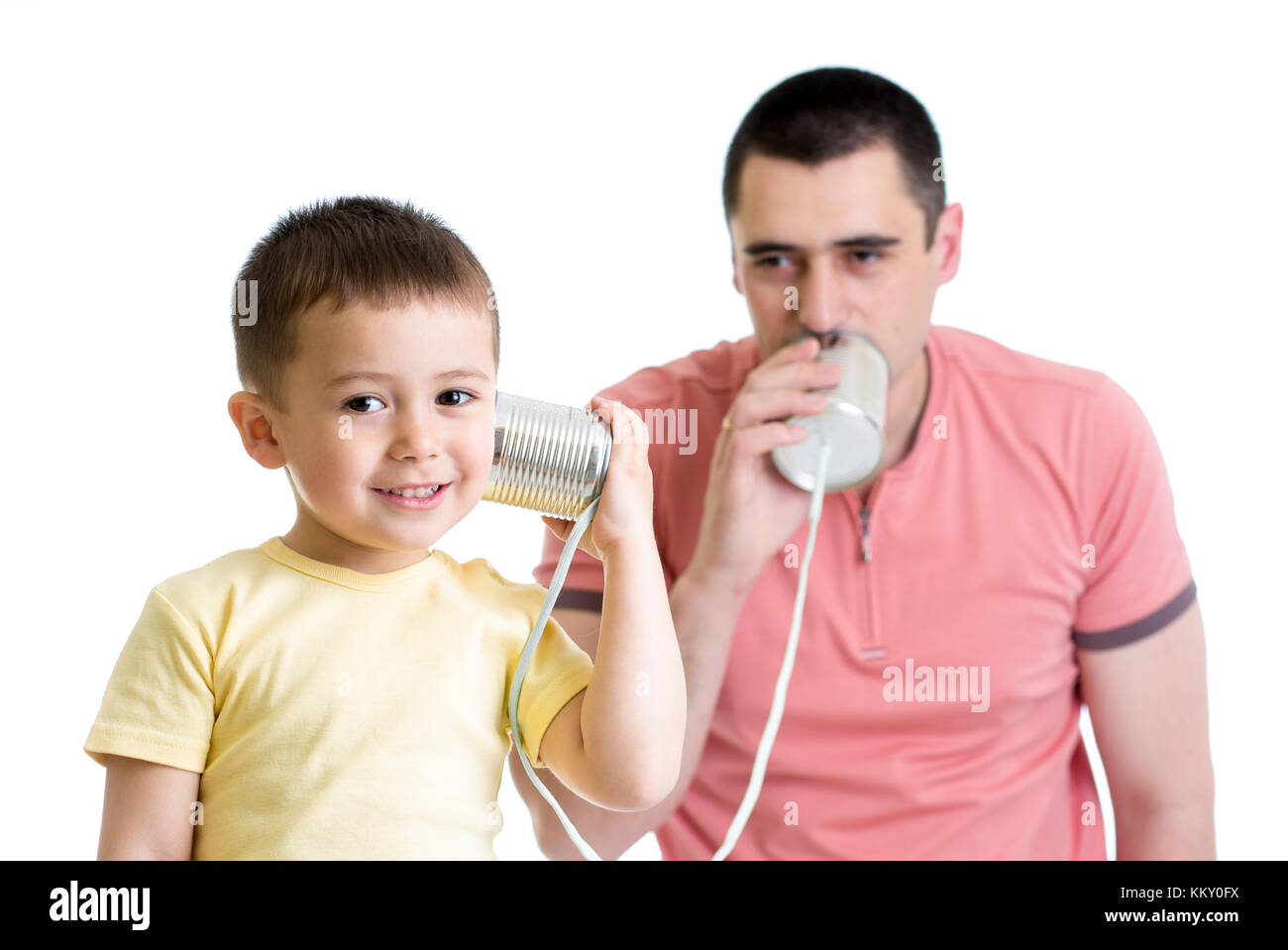 Child boy and dad having a phone call with tin cans Stock Photo