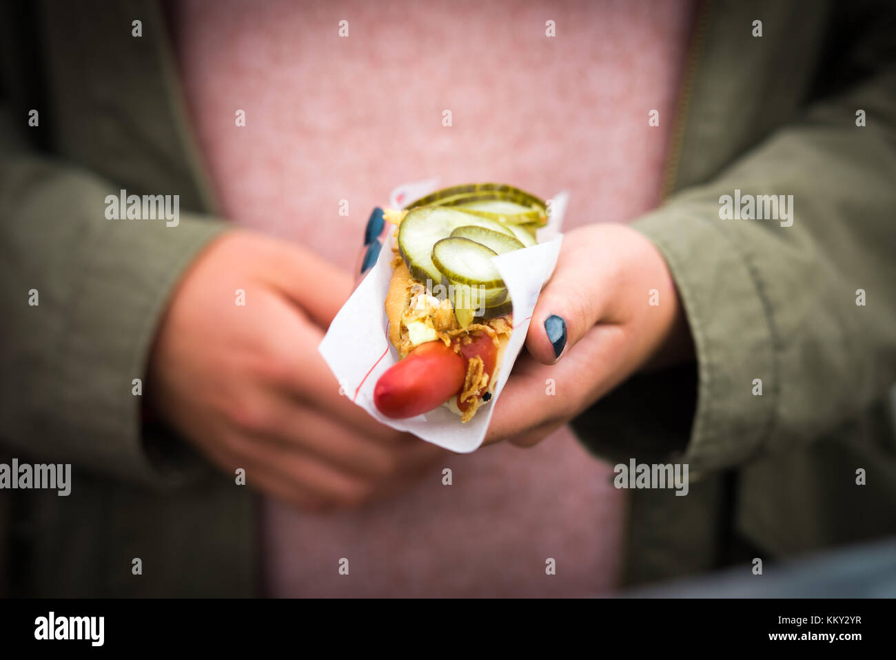 A hot dog in the hands of a girl Stock Photo