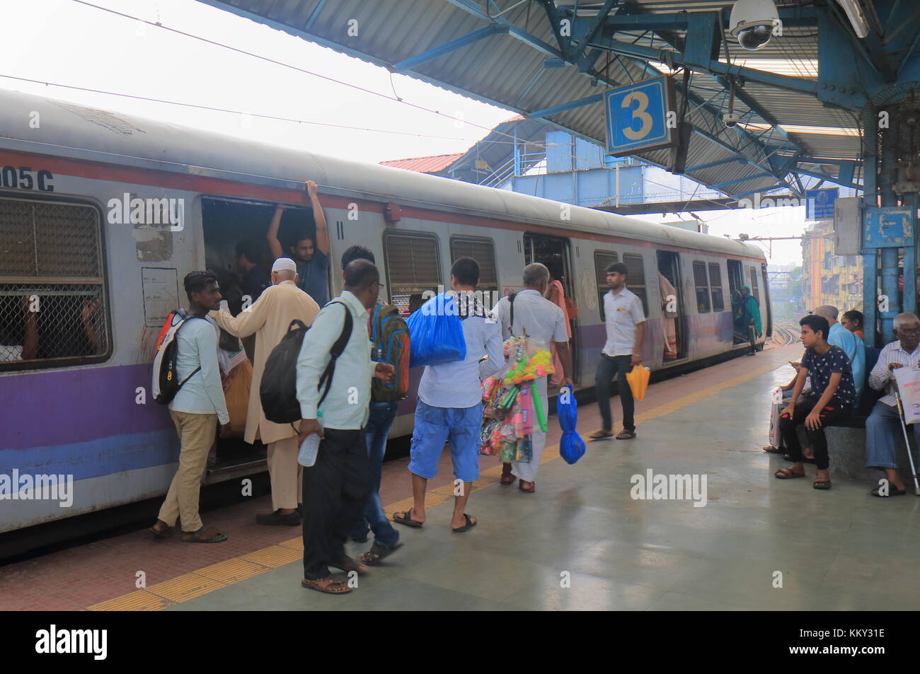 People travel by City train in downtown Mumbai India. Stock Photo