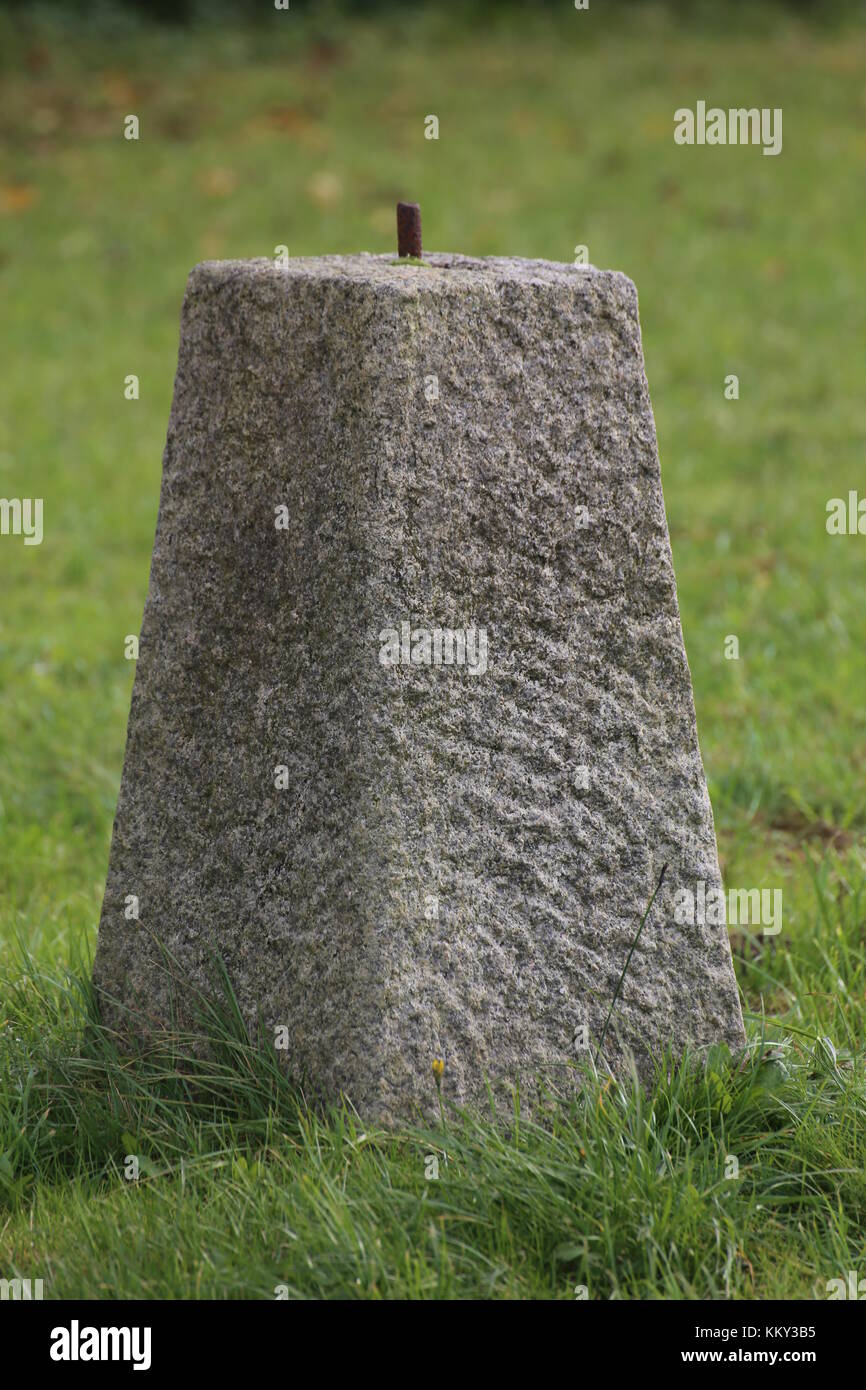 Concrete obelisk standing on a green lawn Stock Photo - Alamy