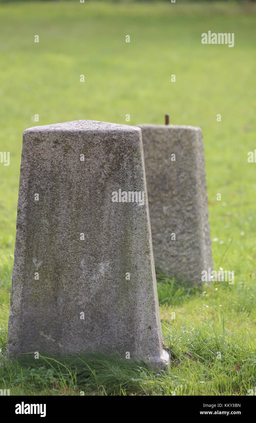 Concrete obelisks standing on a green lawn Stock Photo - Alamy