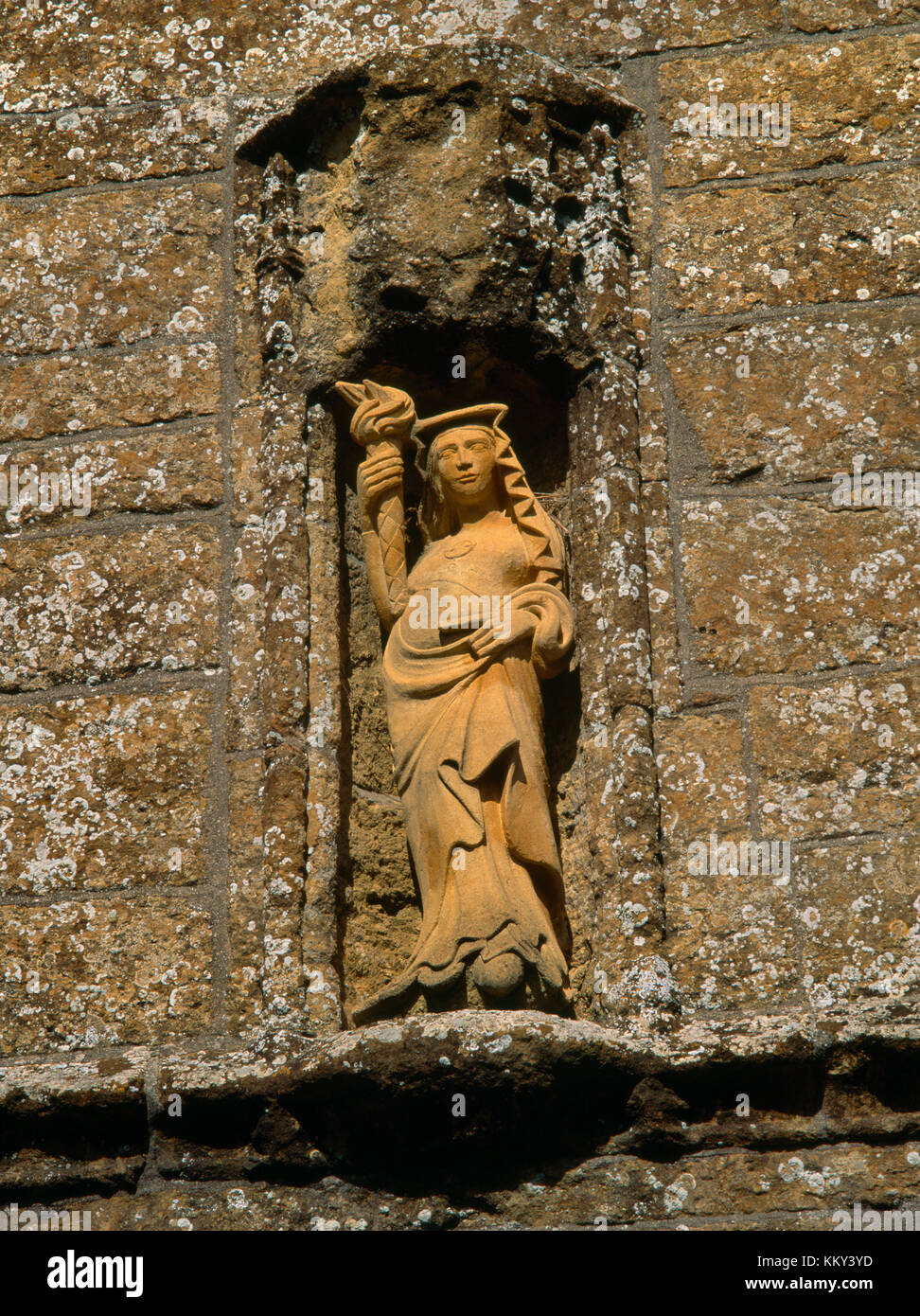 C20th statue of St Candida (St Wite) in niche on S face of C15th Perpendicular tower of St Candida & Holy Cross church, Whitchurch Canonicorum, Dorset Stock Photo