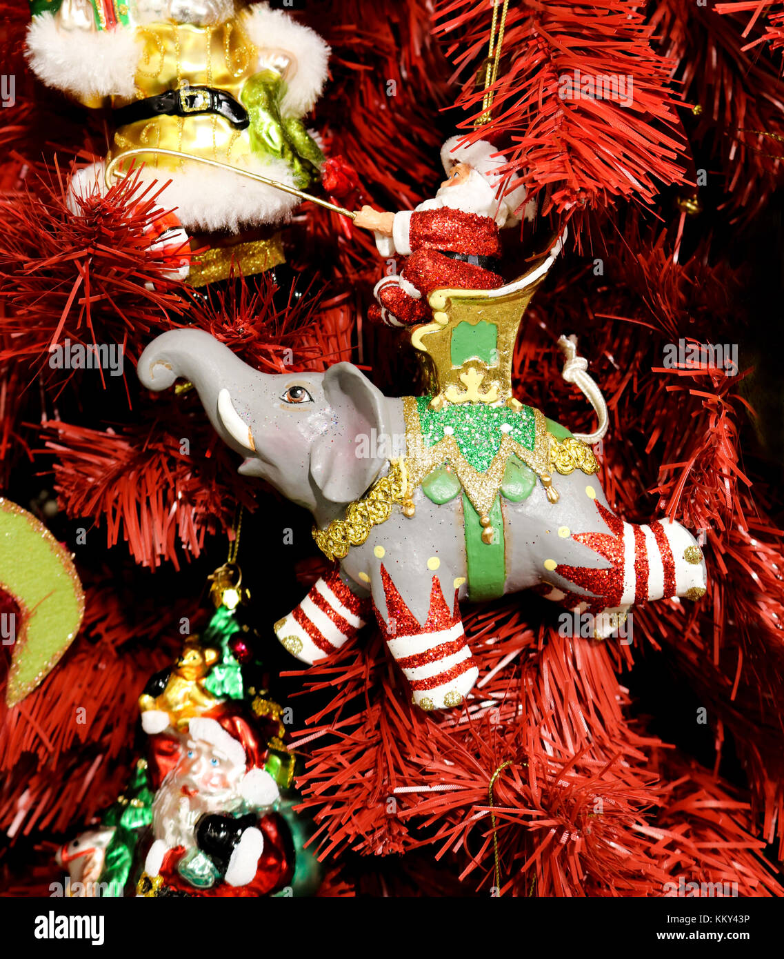 Santa on elephant ornament on red Christmas tree Stock Photo