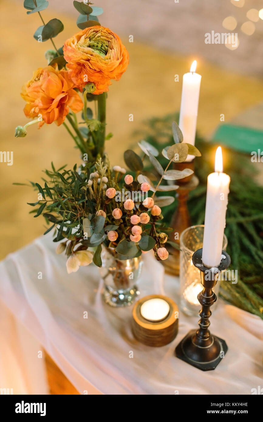 feast, present, floral design concept. on thick drapping two small extremely beautiful posies with bright orange roses, lots of various leaves and sma Stock Photo