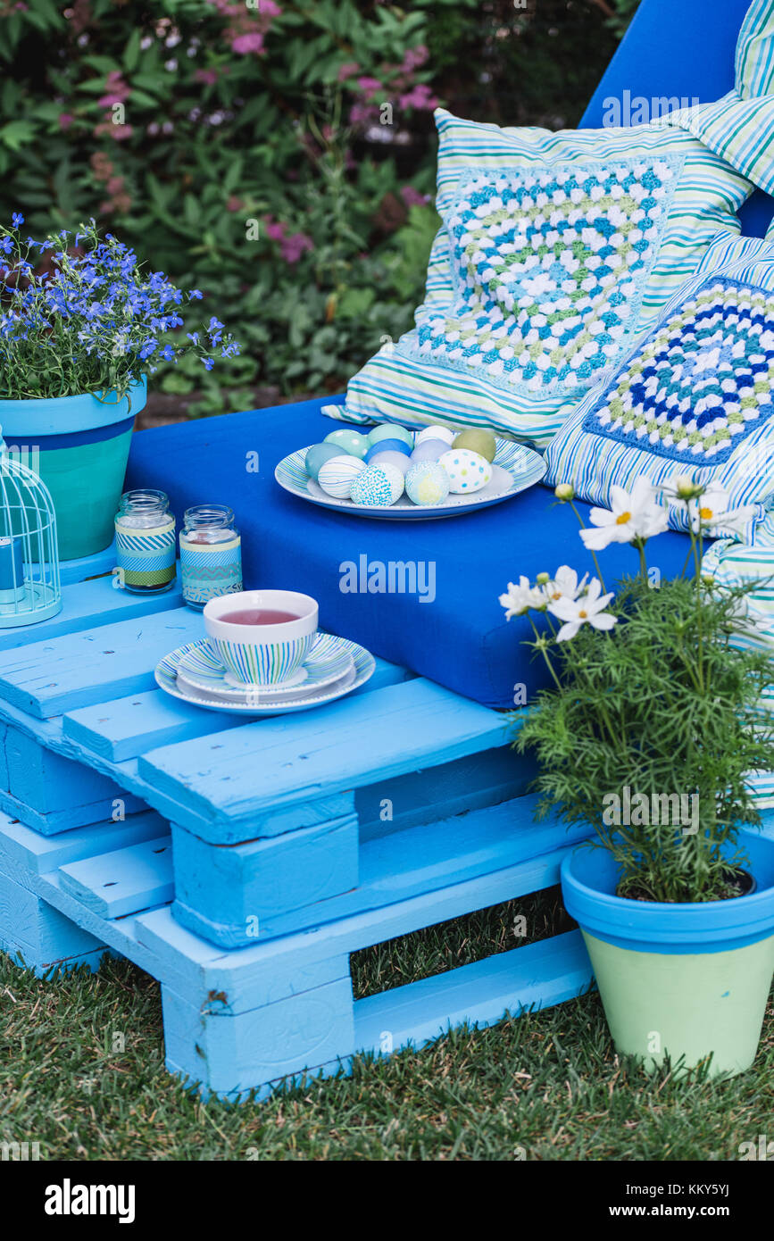 Garden, sofa made of pallets, Easter decoration, detail, flowers Stock