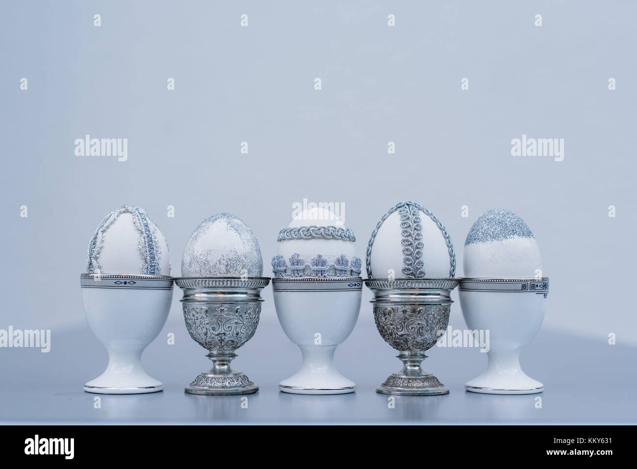 Easter eggs, lace, grey, eggcup, different Stock Photo