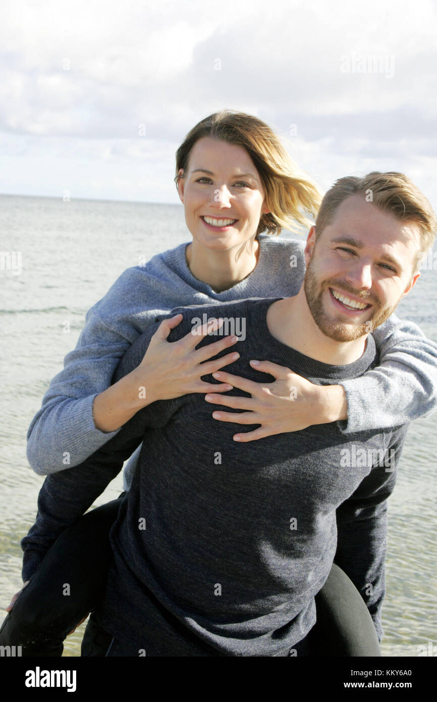 Couple, Baltic Sea beach, walk, piggyback, Stock Photo