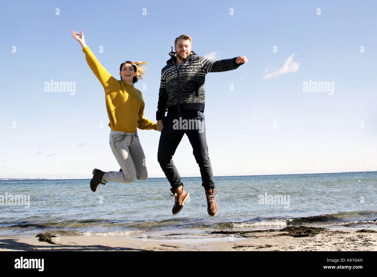 Couple, Baltic Sea, beach walk, jump, Stock Photo