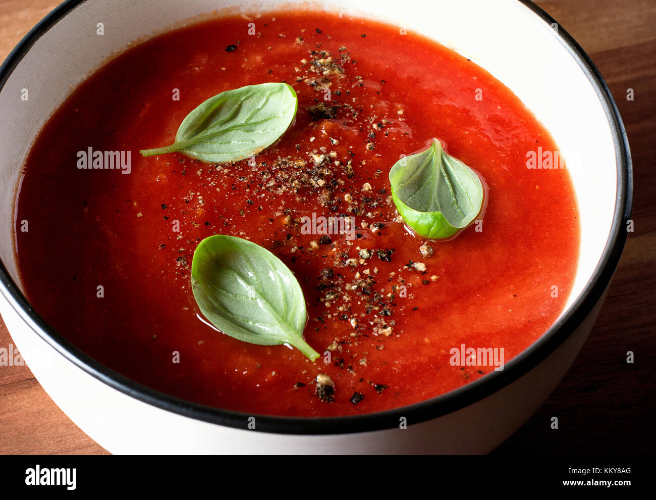 Tomato soup on a rustic wooden table Stock Photo - Alamy