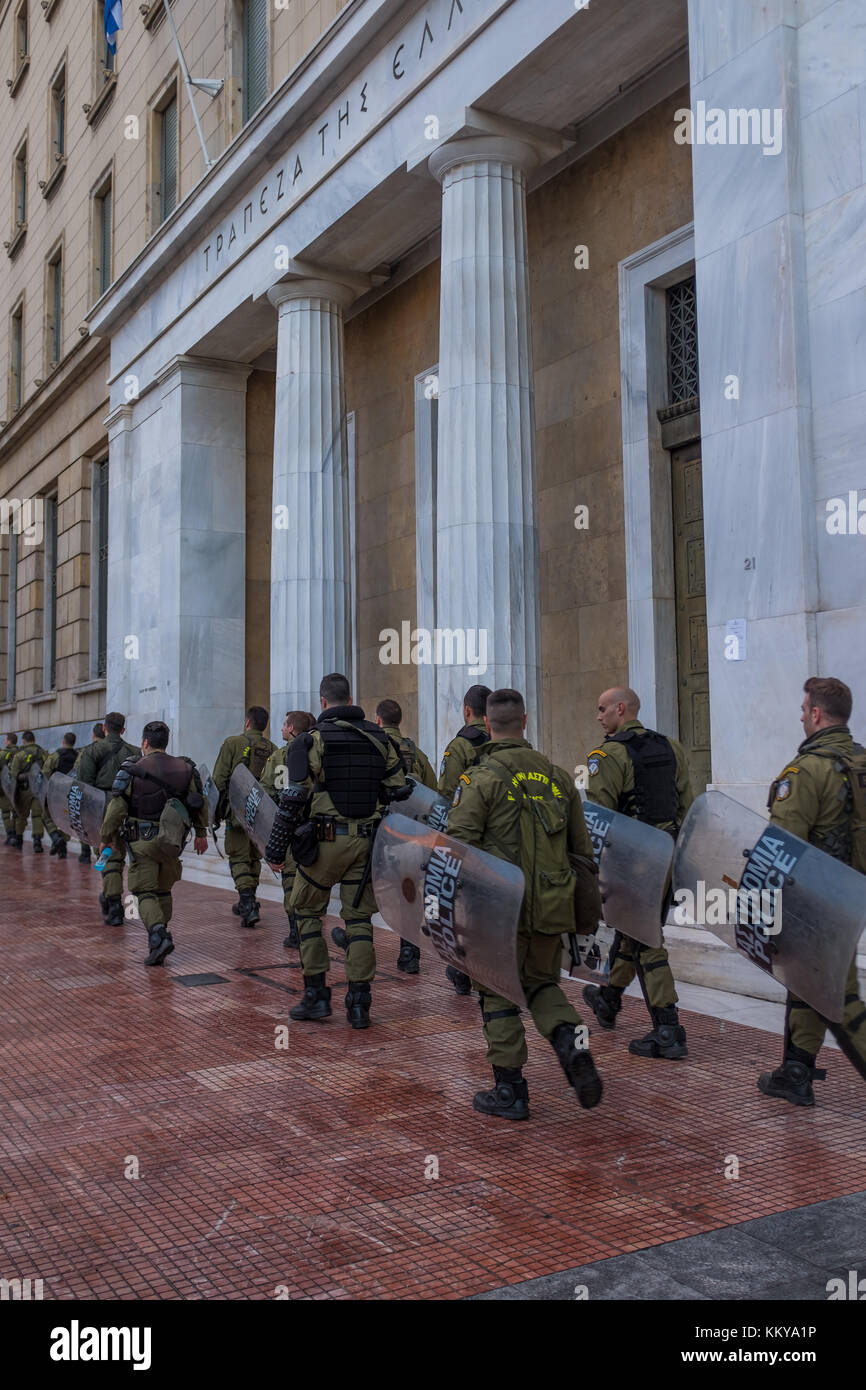 ATHENS, GREECE - NOVEMBER 18 2017: Riot police with their shield, take cover during a rally in front of Athens University, which is under occupation b Stock Photo