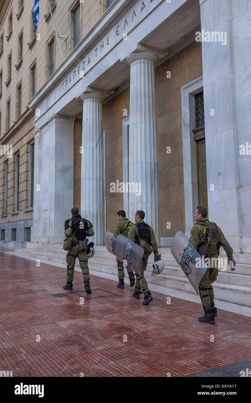ATHENS, GREECE - NOVEMBER 18 2017: Riot police with their shield, take cover during a rally in front of Athens University, which is under occupation b Stock Photo