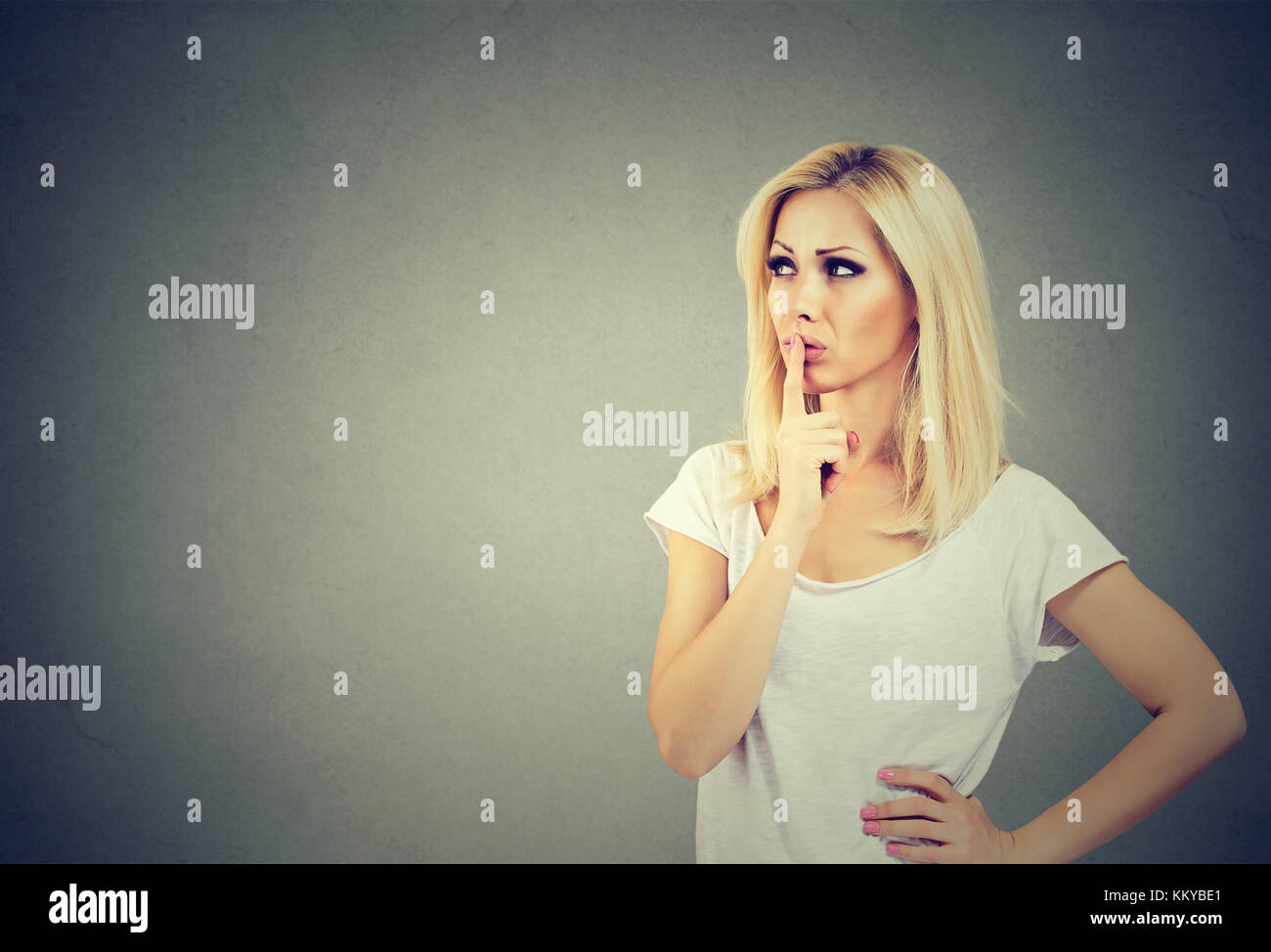 Beautiful woman with a thoughtful face expression looking up Stock Photo