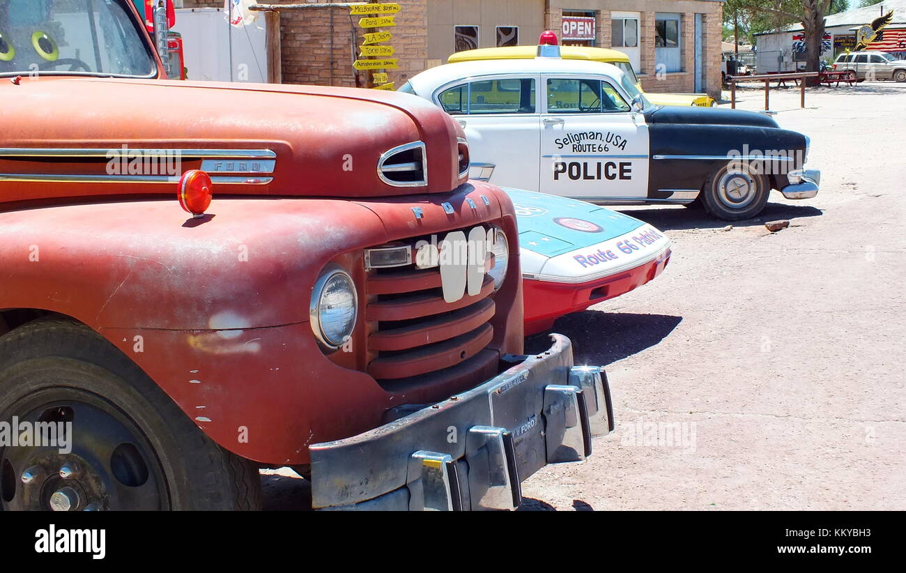 Seligman, Arizona, USA, June 23,2013: 1948 Ford tow truck and vintage Police Car at Seligman Sundries Gift Shop on Route 66. Stock Photo