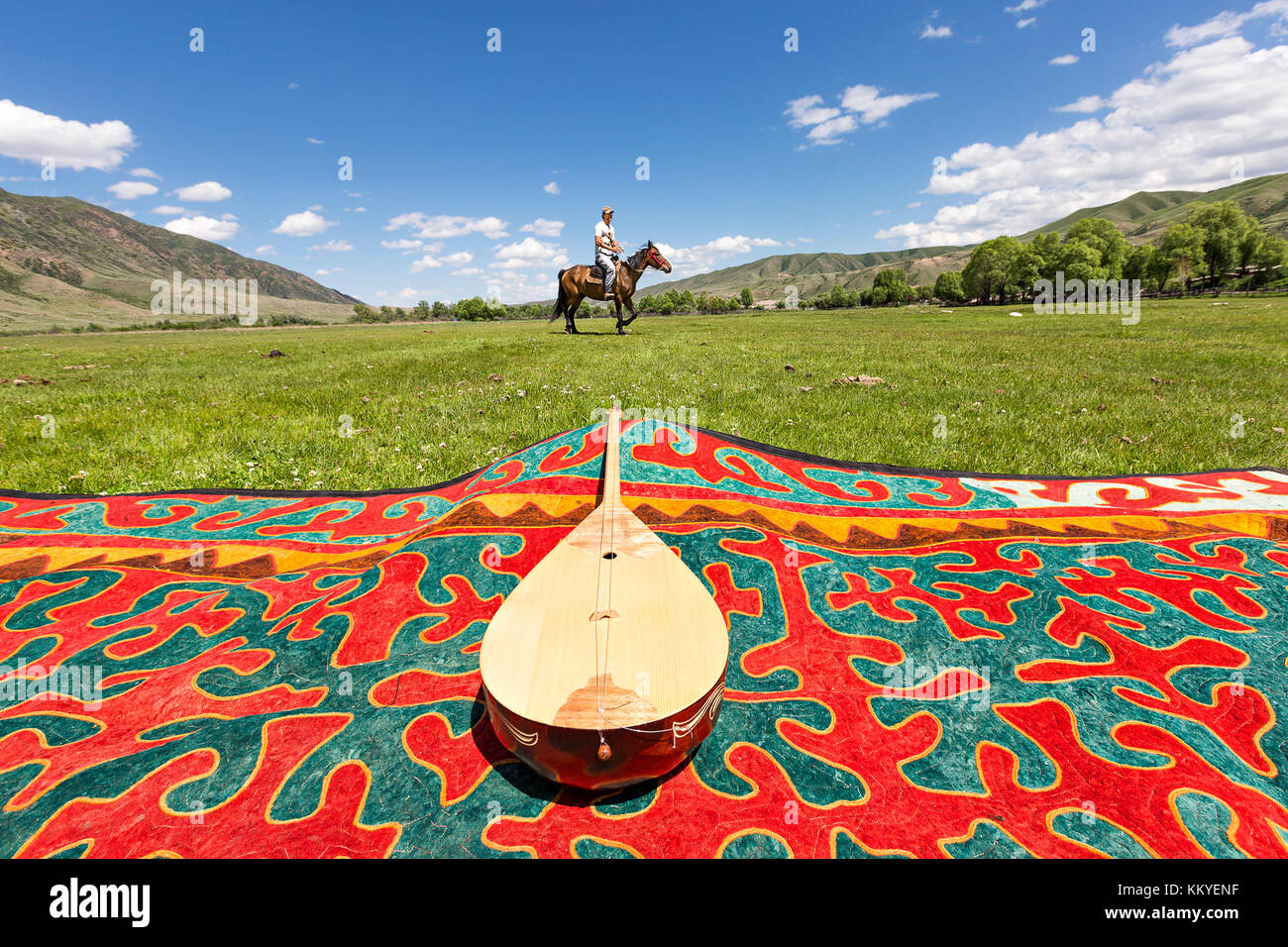 Kazakh national musical instrument known as Dombra and a horse rider, in Saty Village, Kazakhstan. Stock Photo