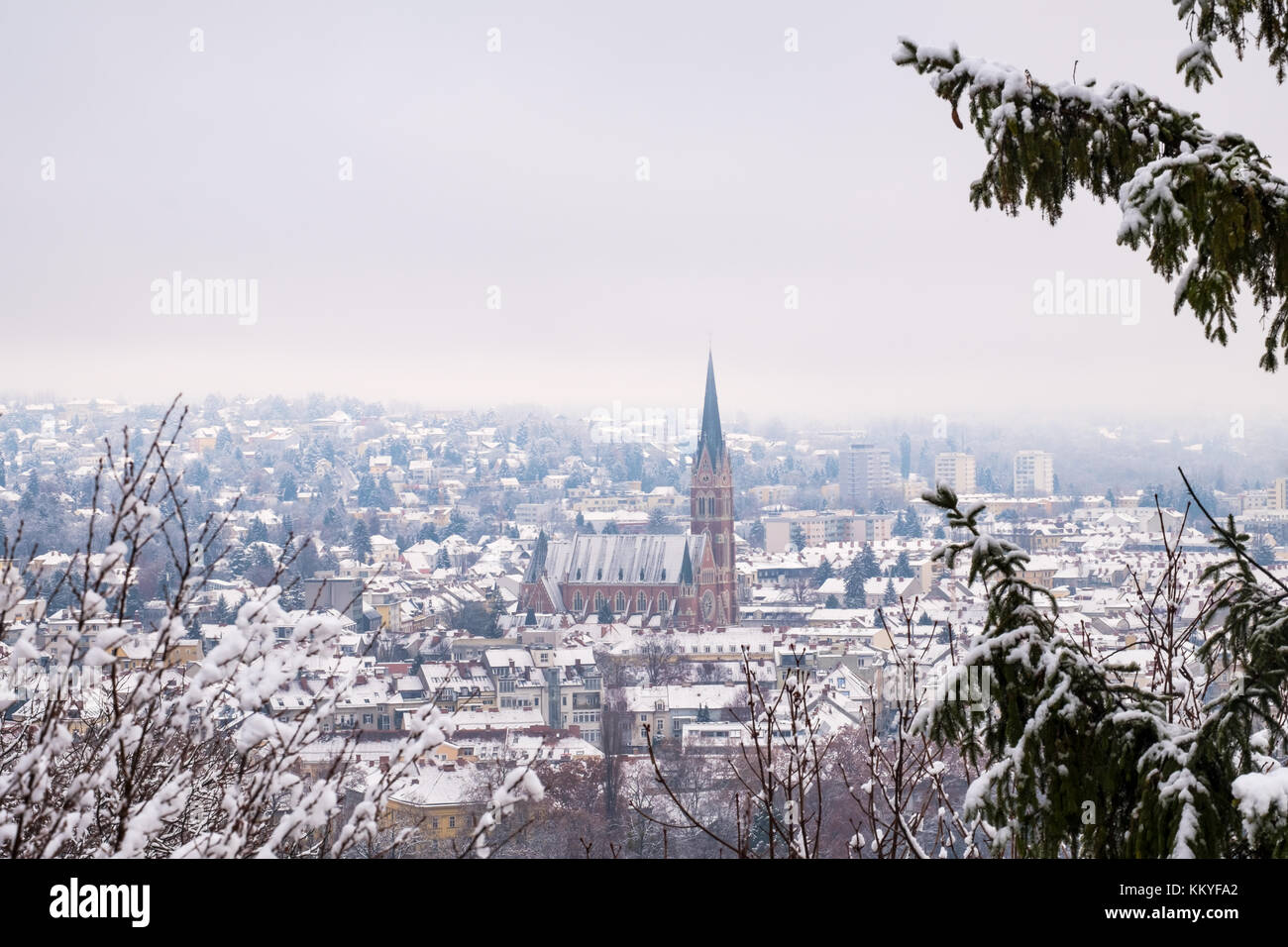 View from Schlossberg in Graz to Herz-Jesu-Church with some snow in winter Stock Photo