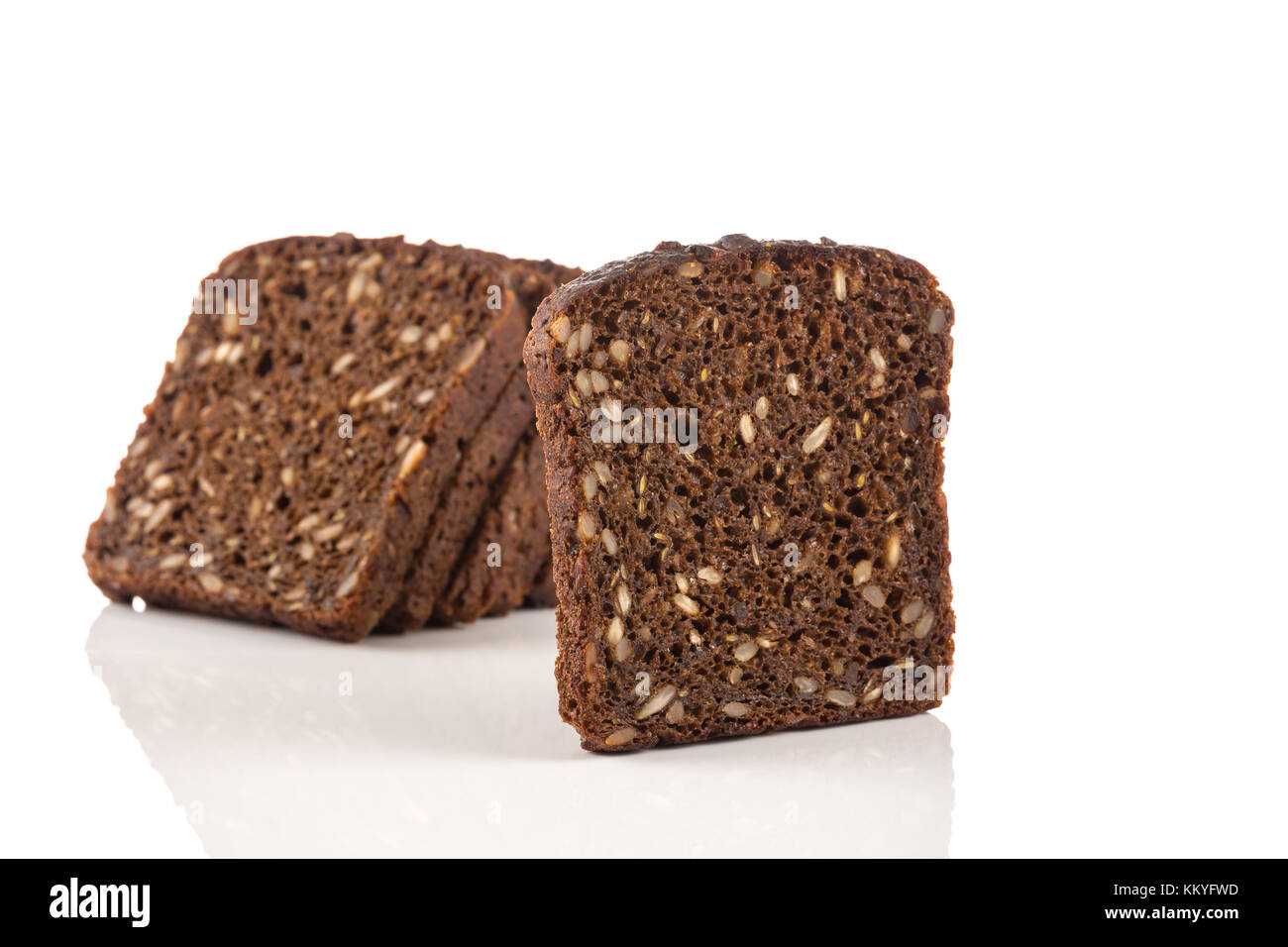 Dark rye bread with sunflower seeds on a white background Stock Photo