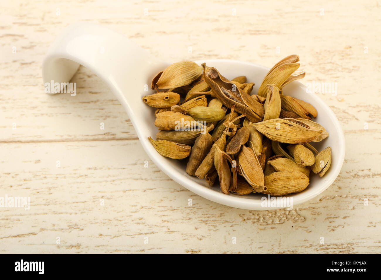 Dry cardamom seeds heap in the bowl Stock Photo - Alamy