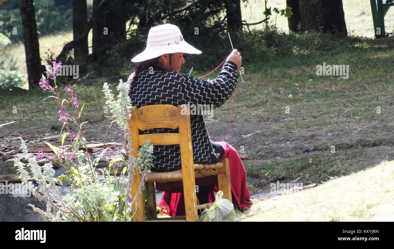 Mexican indigenous women hand sewing colorful textiles in Mexico Stock