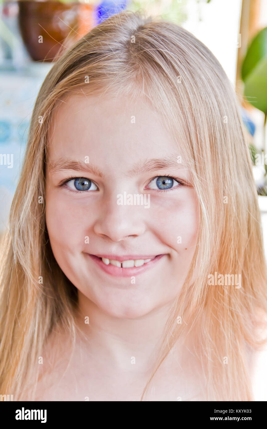 Cute girl with blond long hair and blue eyes Stock Photo - Alamy