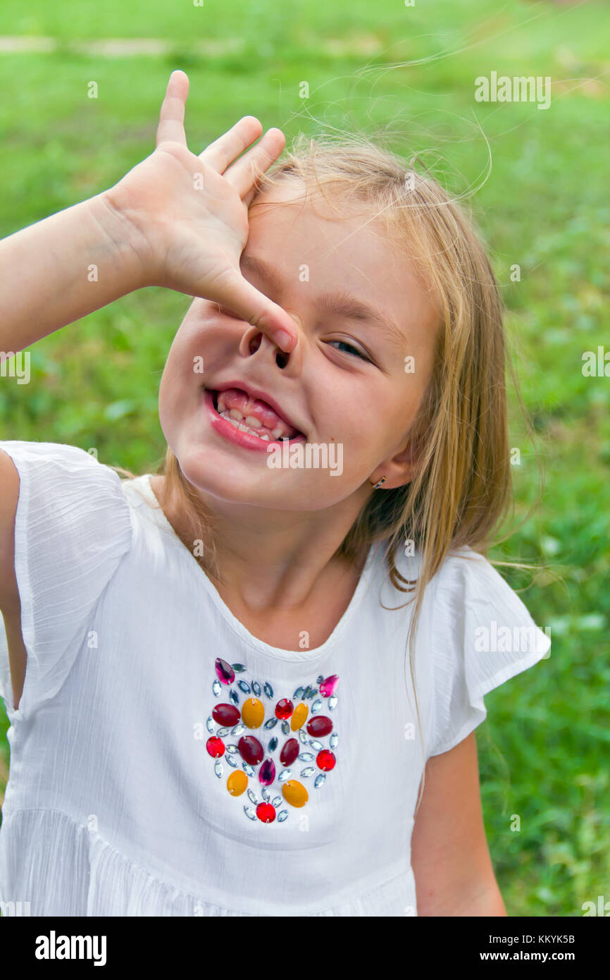 Cute beautiful girl makes faces imitate witch Stock Photo