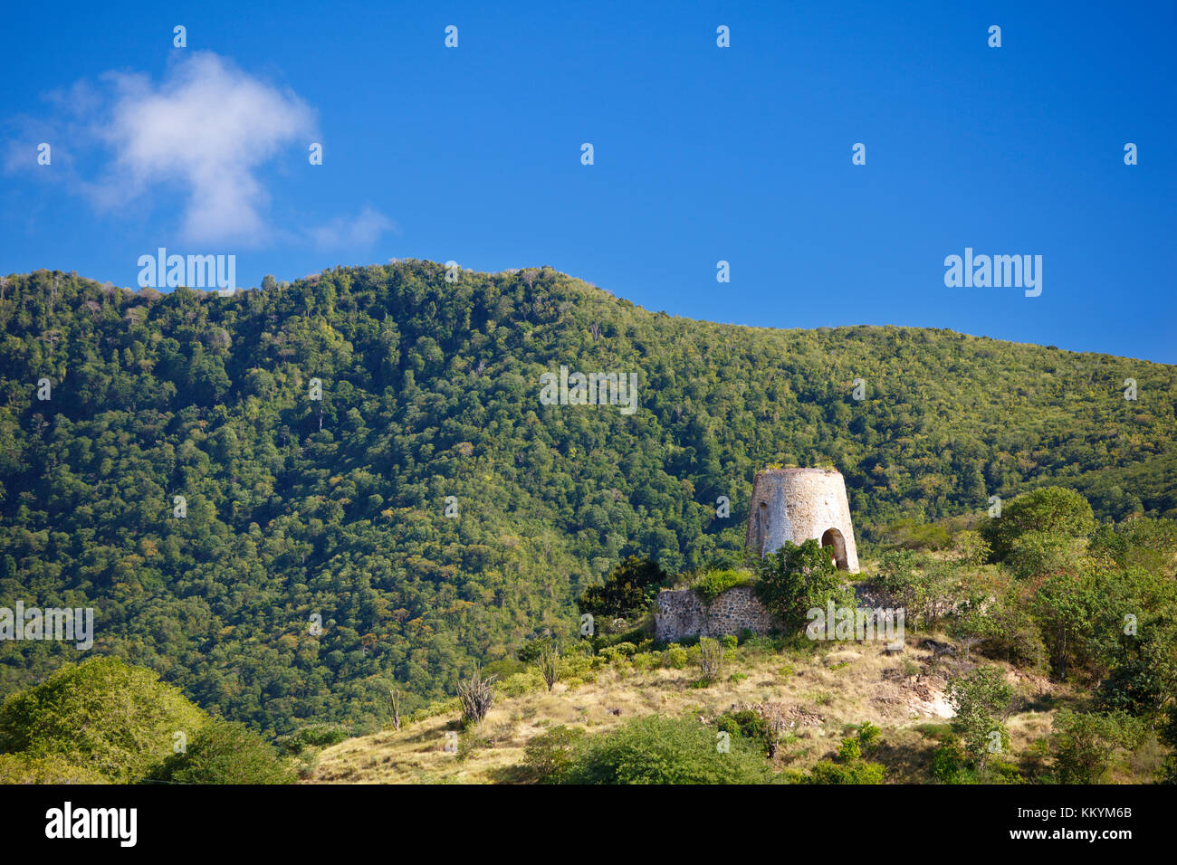 The ruin of an old windmill in Antiguan hill landscape. Stock Photo