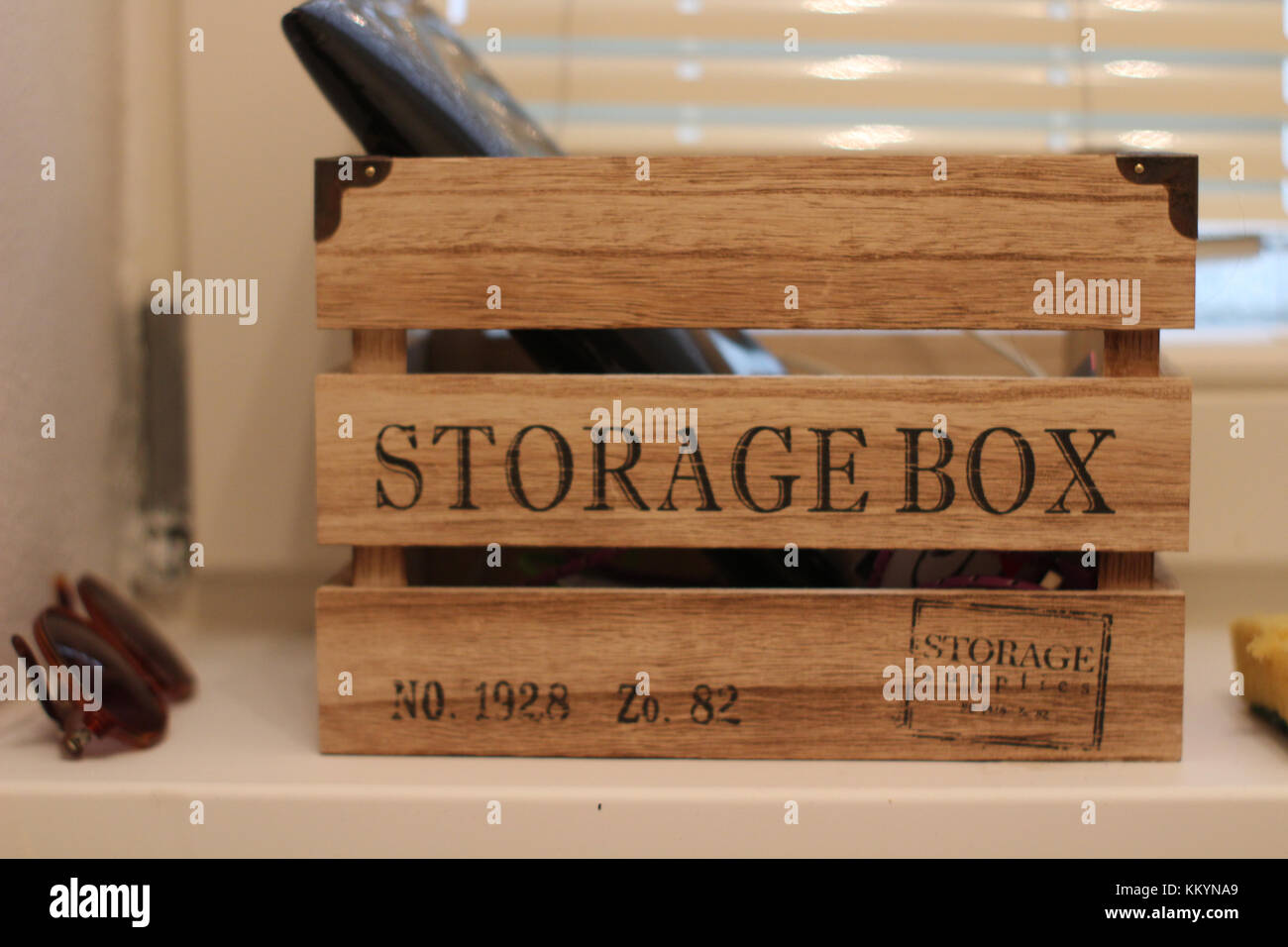 wooden storage box with sunglasses and other things inside it as a decoration on a home sae space Stock Photo