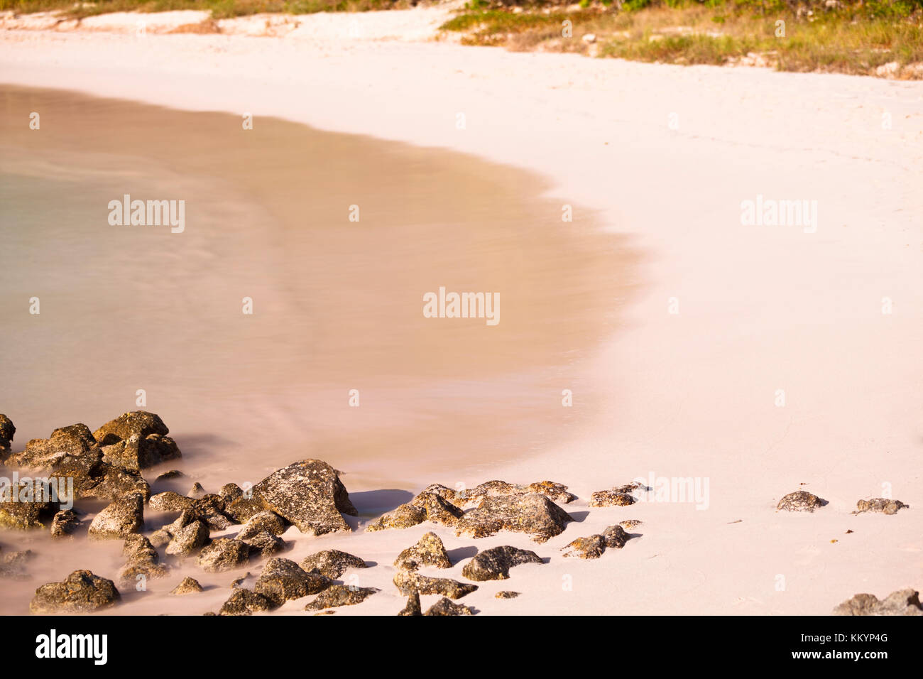 Daytime long exposure of the beautiful Half Moon Bay in Antigua. Stock Photo