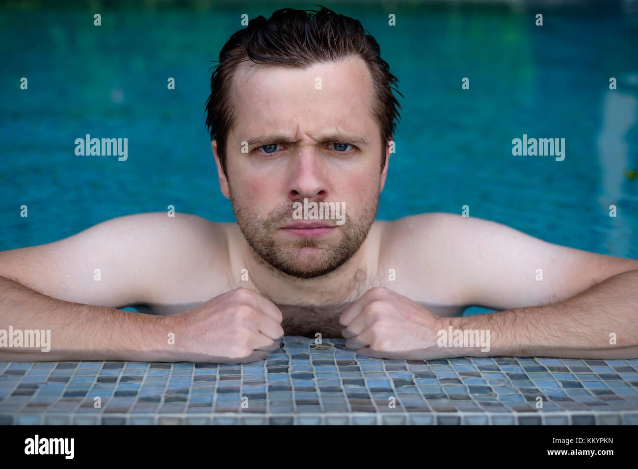 grumpy man rest in swimming pool. Stock Photo