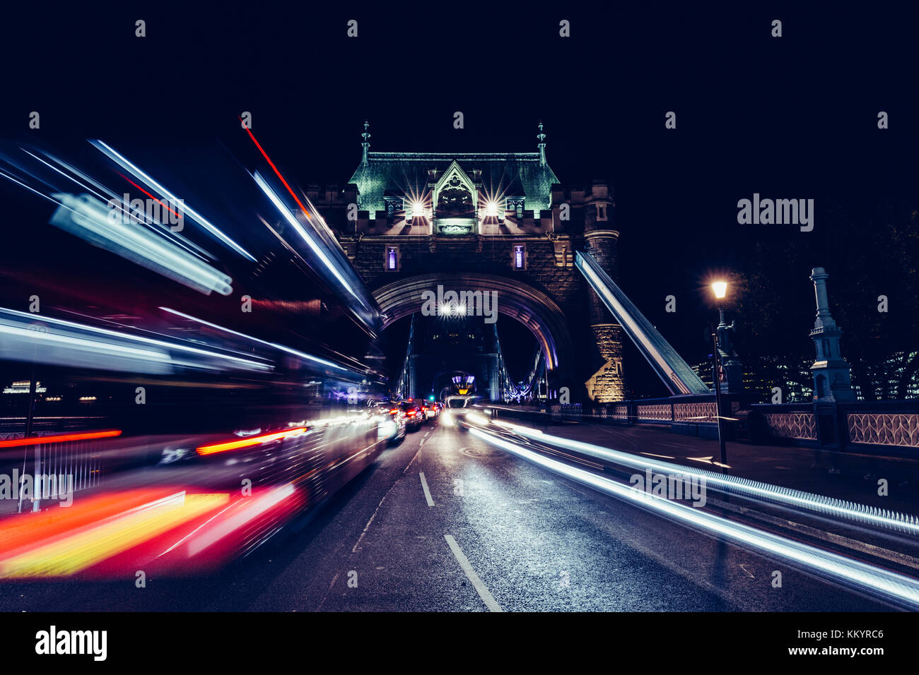 City light trails of red London bus traffic on Tower Bridge in London ...