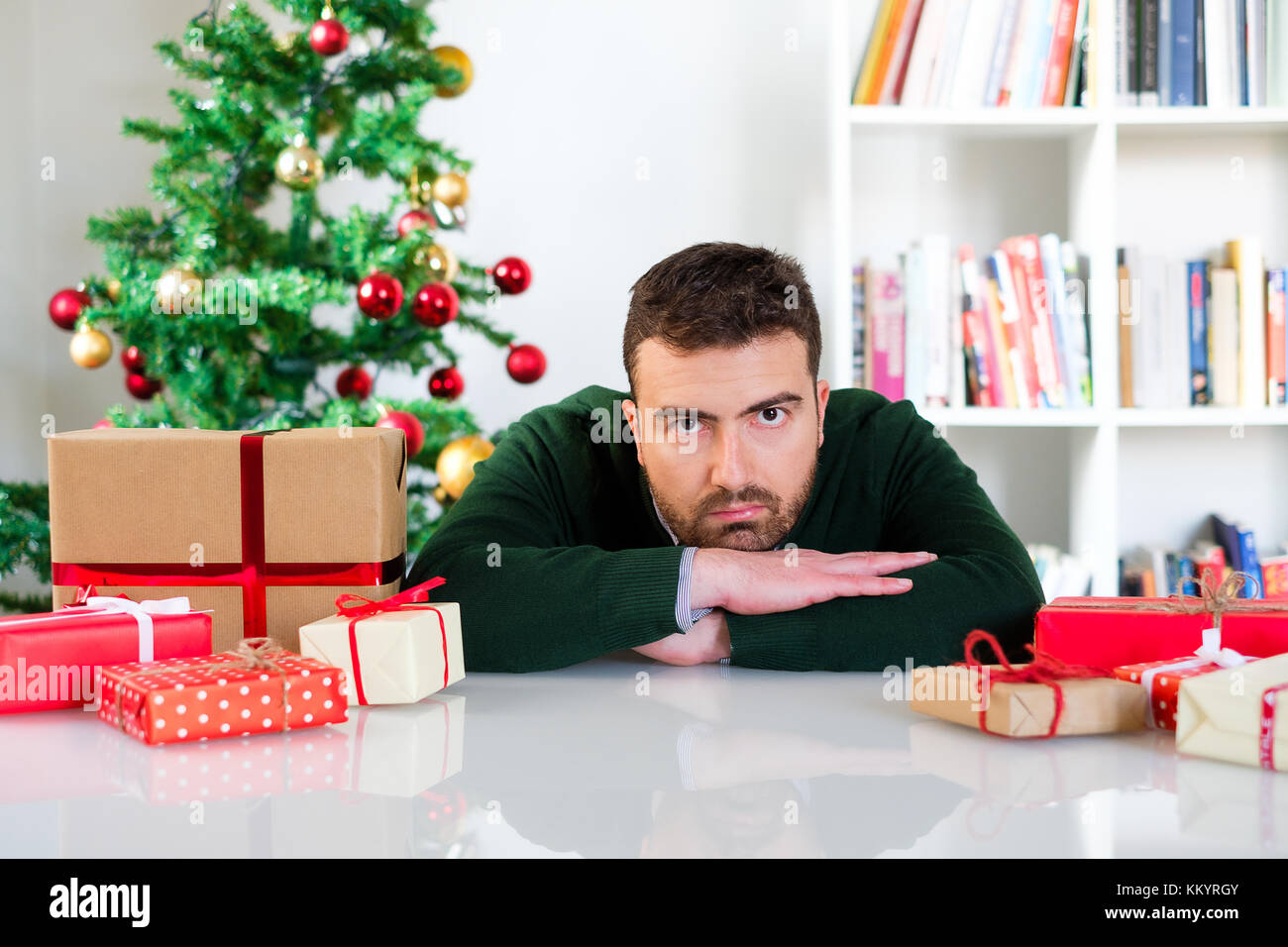 Man frustrated by the christmas presents , negative emotion Stock Photo