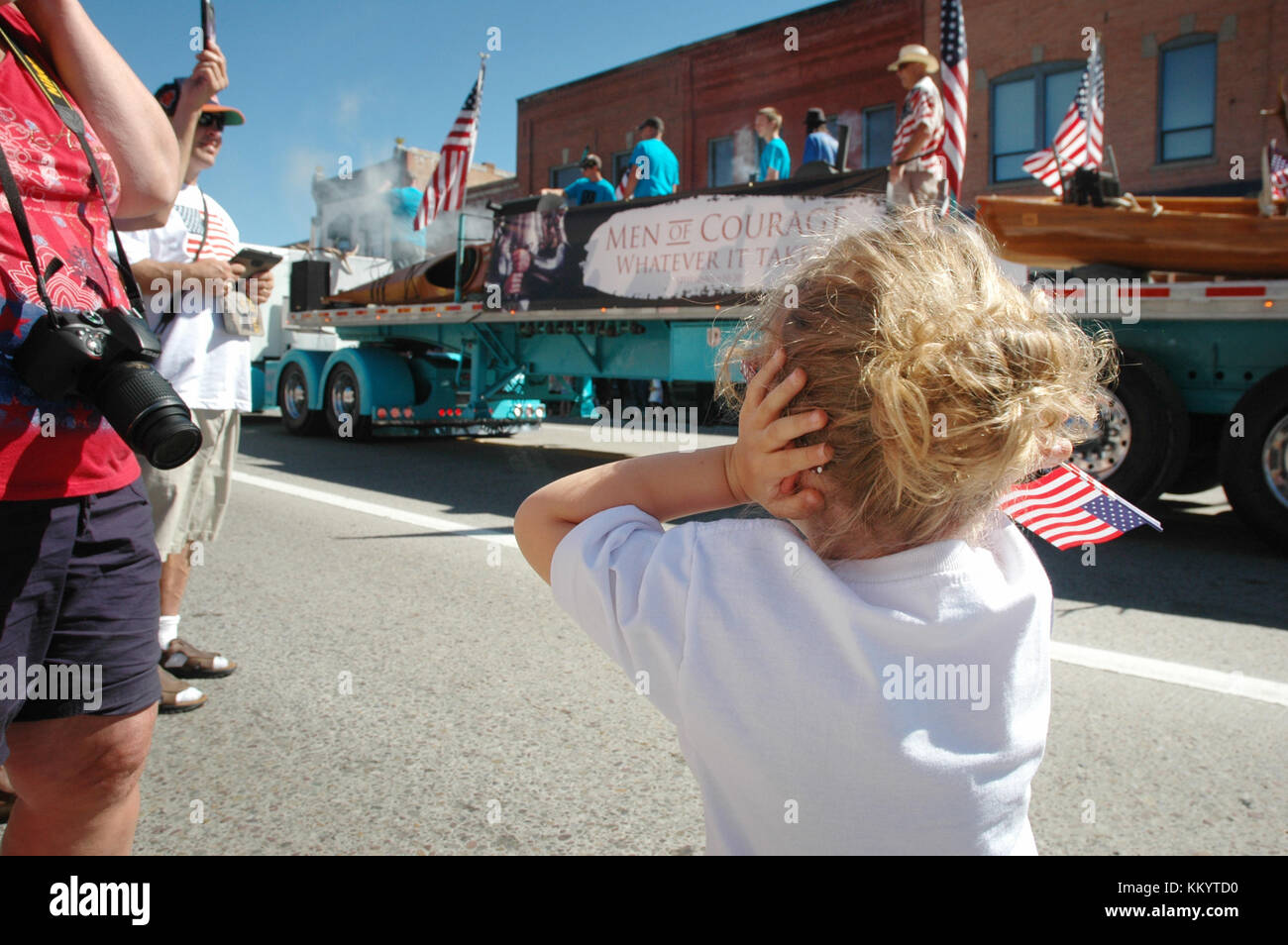 KALISPELL, MT, USA - JULY 4: Girl covers ears after a loud boom during 4th of July Parade in Kalispell, Montana, on July 4, 2016 Stock Photo
