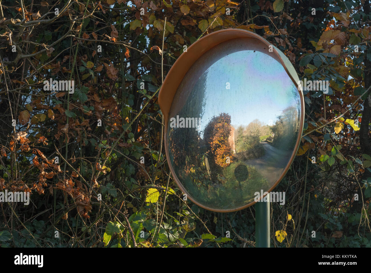 Convex road safety mirror on a rural road in UK. Stock Photo