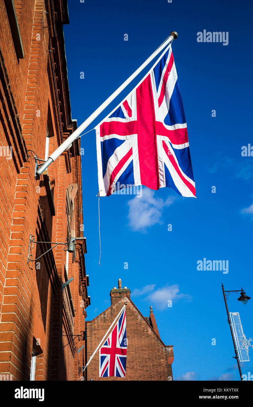 Union Jack flags hang from the King Edward VII Memorial Hall in Newmarket UK. The hall was donated to the town in 1911 by Sir Ernest Cassell Stock Photo
