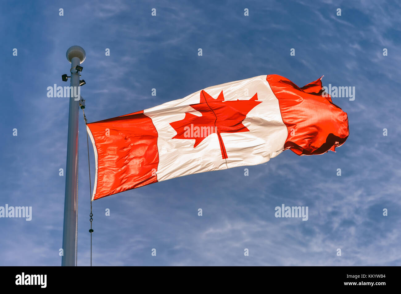 Flag of Canada flying against a blue sky in Vancouver, BC, Canada Stock Photo