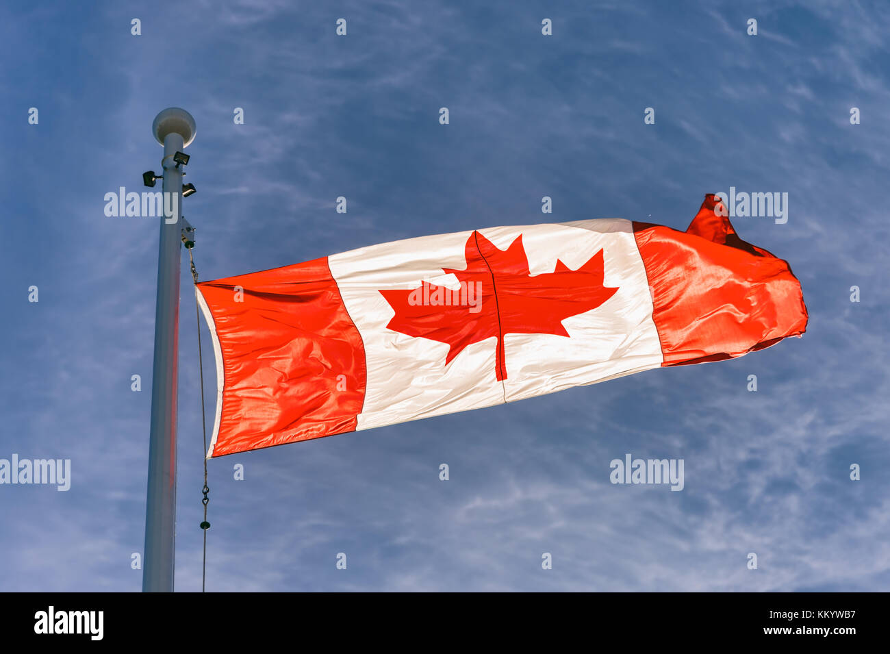 Flag of Canada flying against a blue sky in Vancouver, BC, Canada Stock Photo